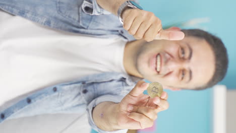 Vertical-video-of-Man-holding-bitcoin-and-showing-it.